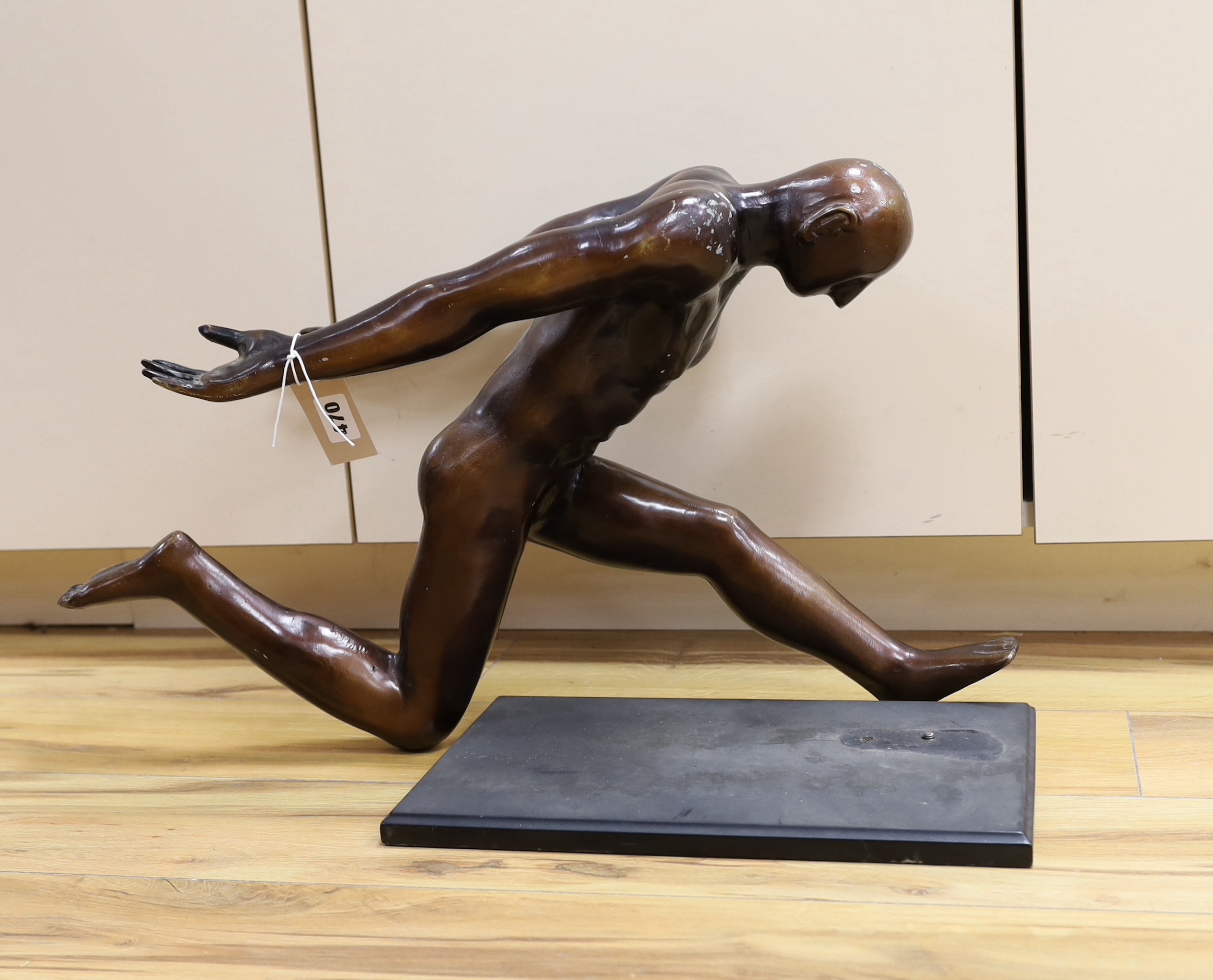 A patinated spelter figure of an Olympian figure, 62 cm wide x 52cm high